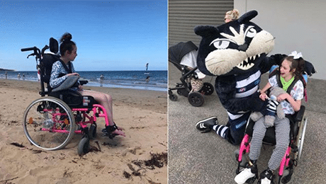 A client in her wheelchair on the beach and on the right she with AFL mascot