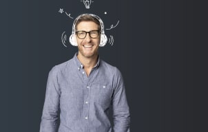 A man standing smiling wearing illustrated headphones