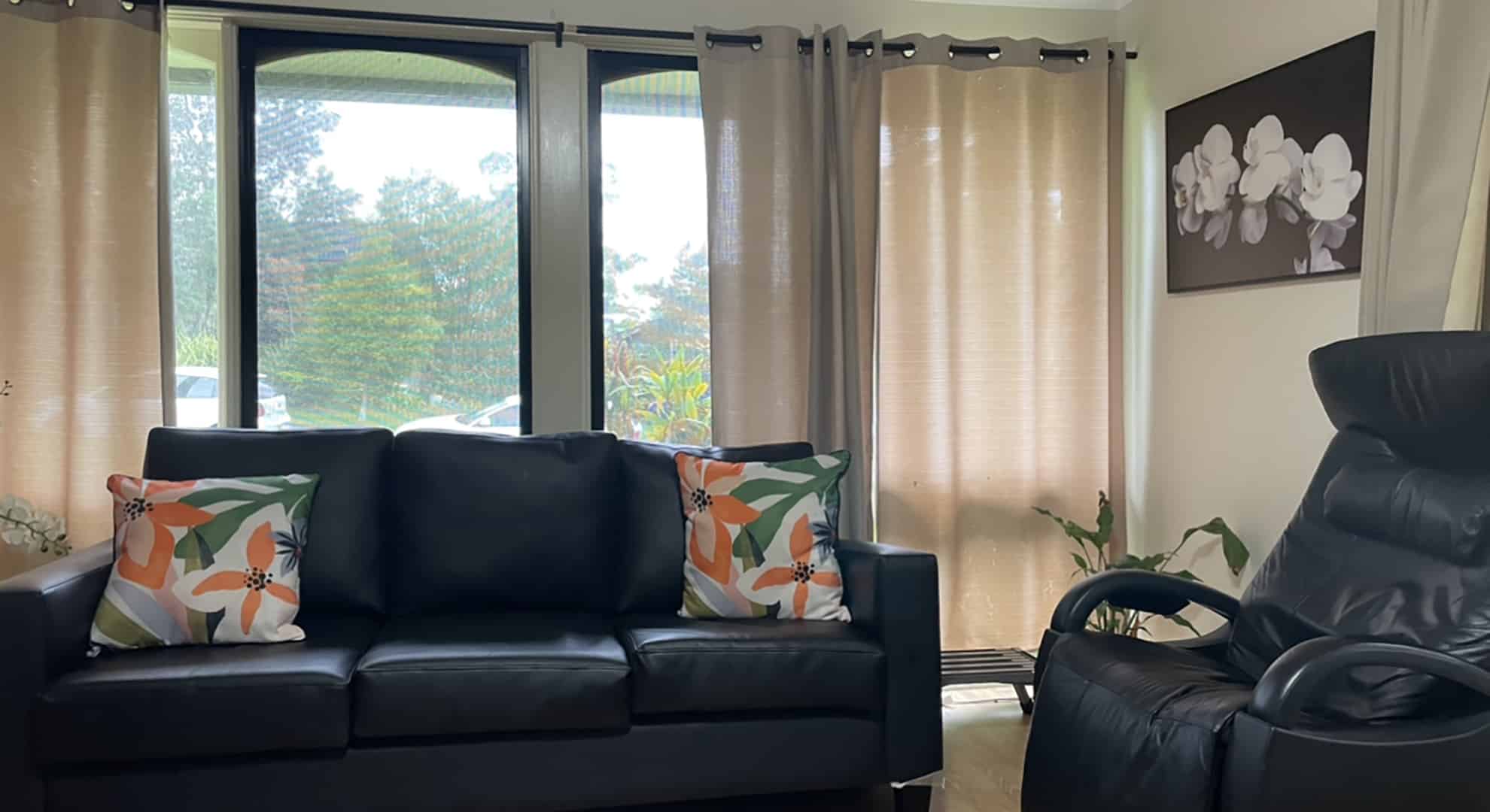 A living room with couches in front of a window.