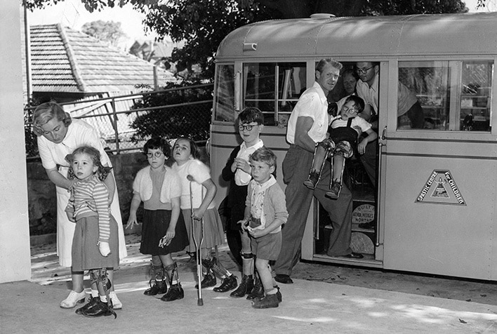 A group of children with CP and adults arriving at the original Spastic Centre