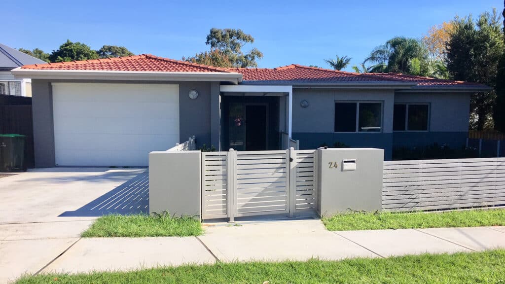 Front view of the house with secure garage and gated front yard at Denistone East.