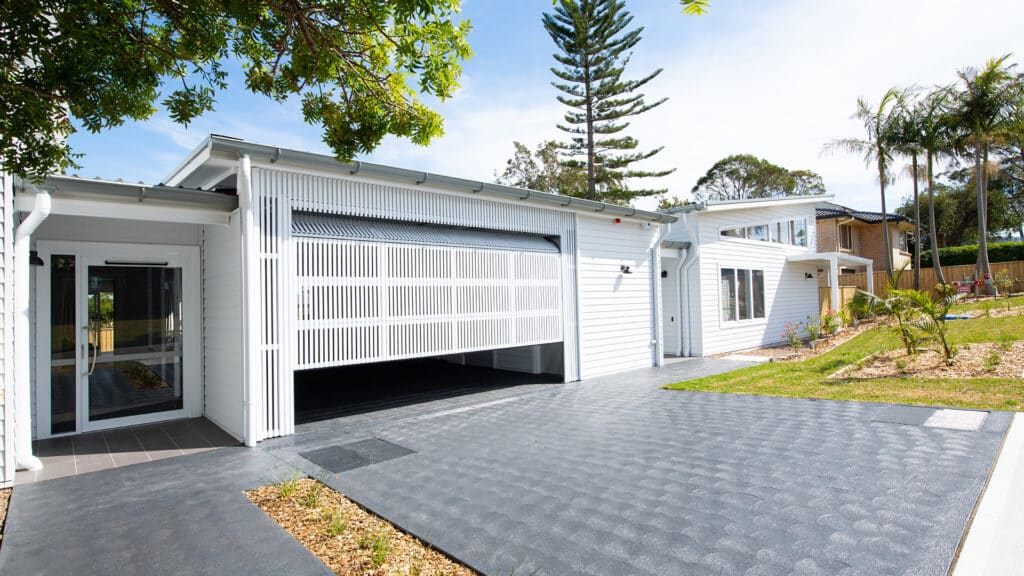 Front view of the house with secure garage and open grassed garden