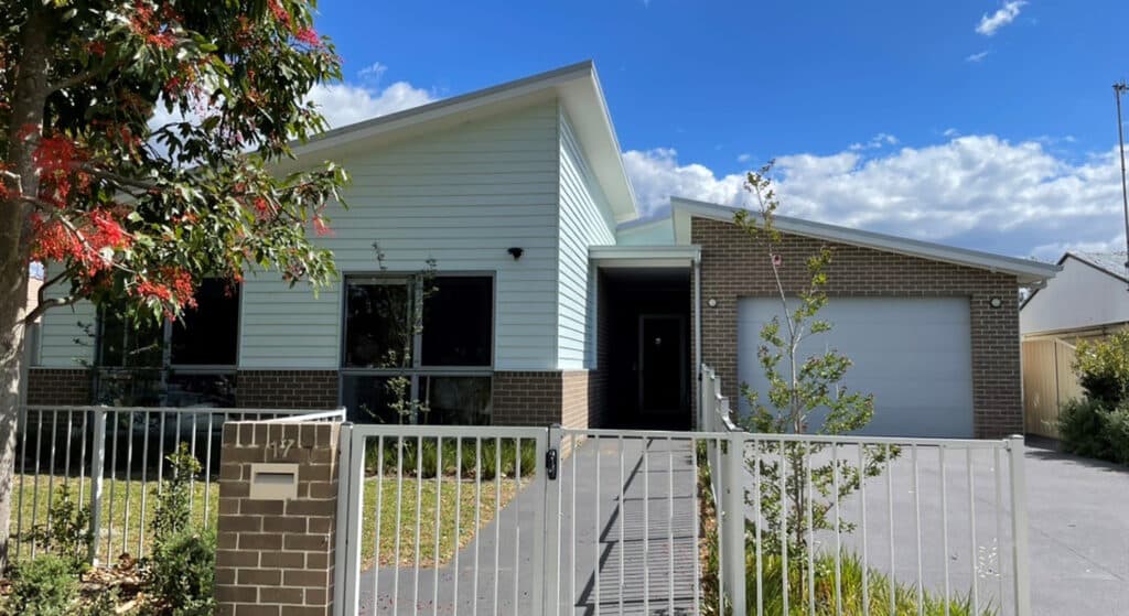 Front view of the house with secure garage and fenced garden