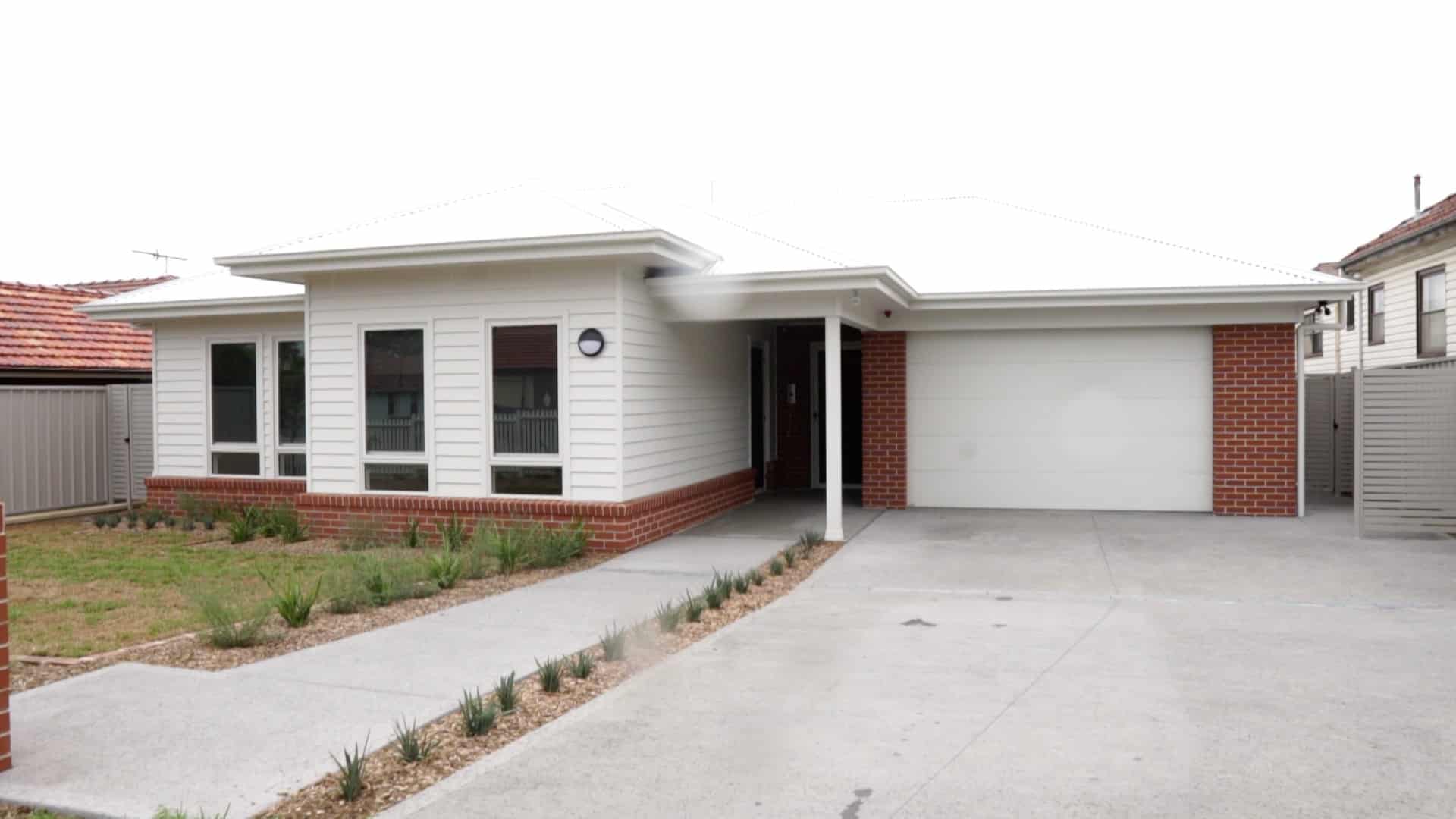 Front view of the home with secure garage and front garden
