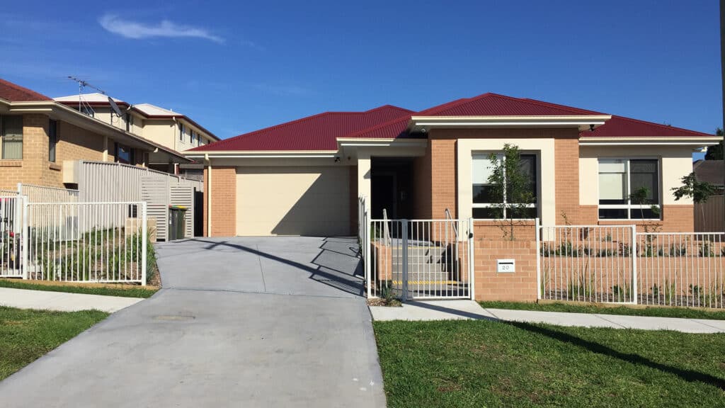 Front view of the house with secure garage and gated front yard