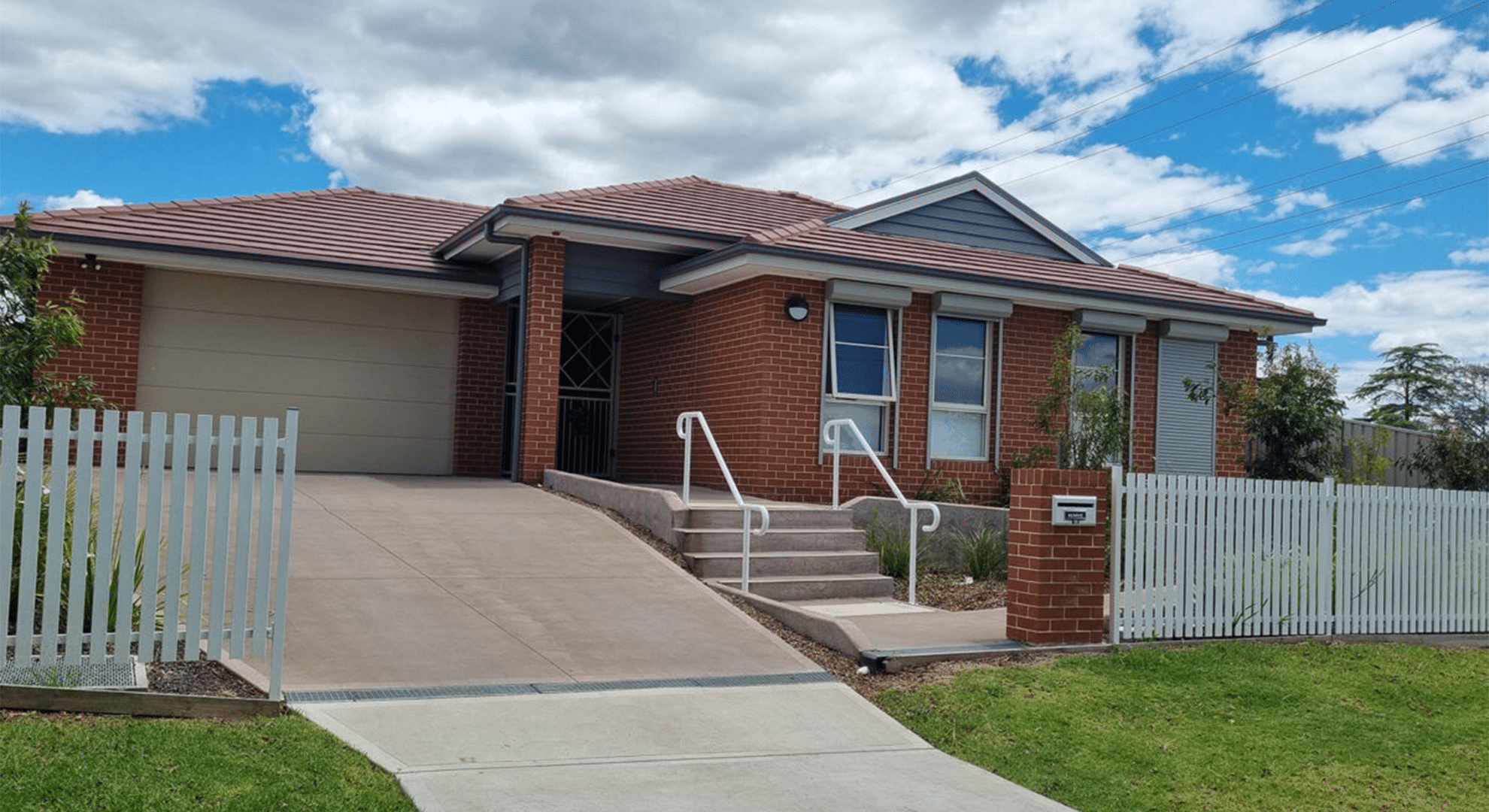 Front view of the brick, single story Wallsend SIL home