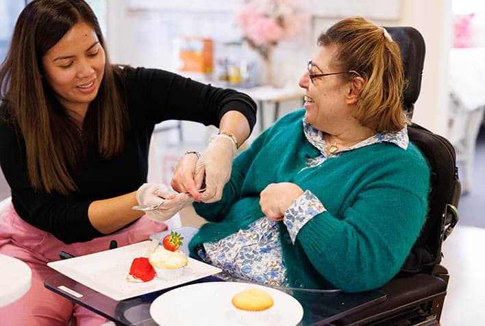 A support worker assisting a client with a meal time