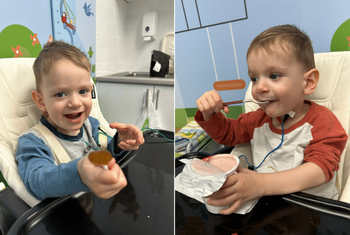 Two year old Harvey sitting in a highchair with the VitalStim device attached to his outer neck, holding a lollypop and smiling, next to an image of him sitting in a highchair holding a tub of yoghurt with a spoon in his mouth.