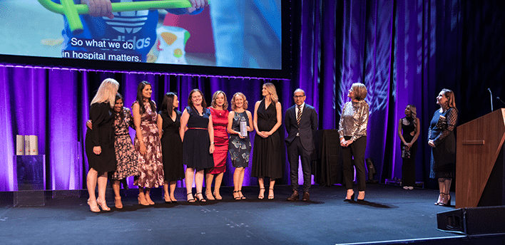 The team from the Grace Centre for Intensive Care standing on stage together to receive the NSW Health Research award.