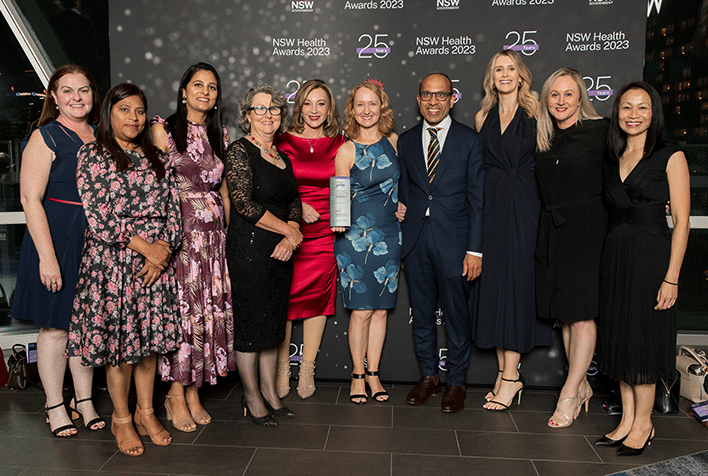 The team from the Grace Centre for Newborn Intensive care standing together, smiling after receiving the NSW Health Research award.