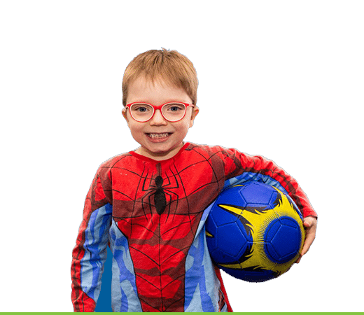 a boy in spider man suit holding a ball