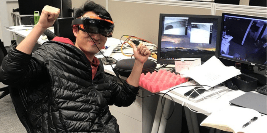 A man sitting at a desk using virtual reality software
