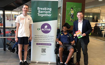 Three males posing for a photo next to a CPActive banner