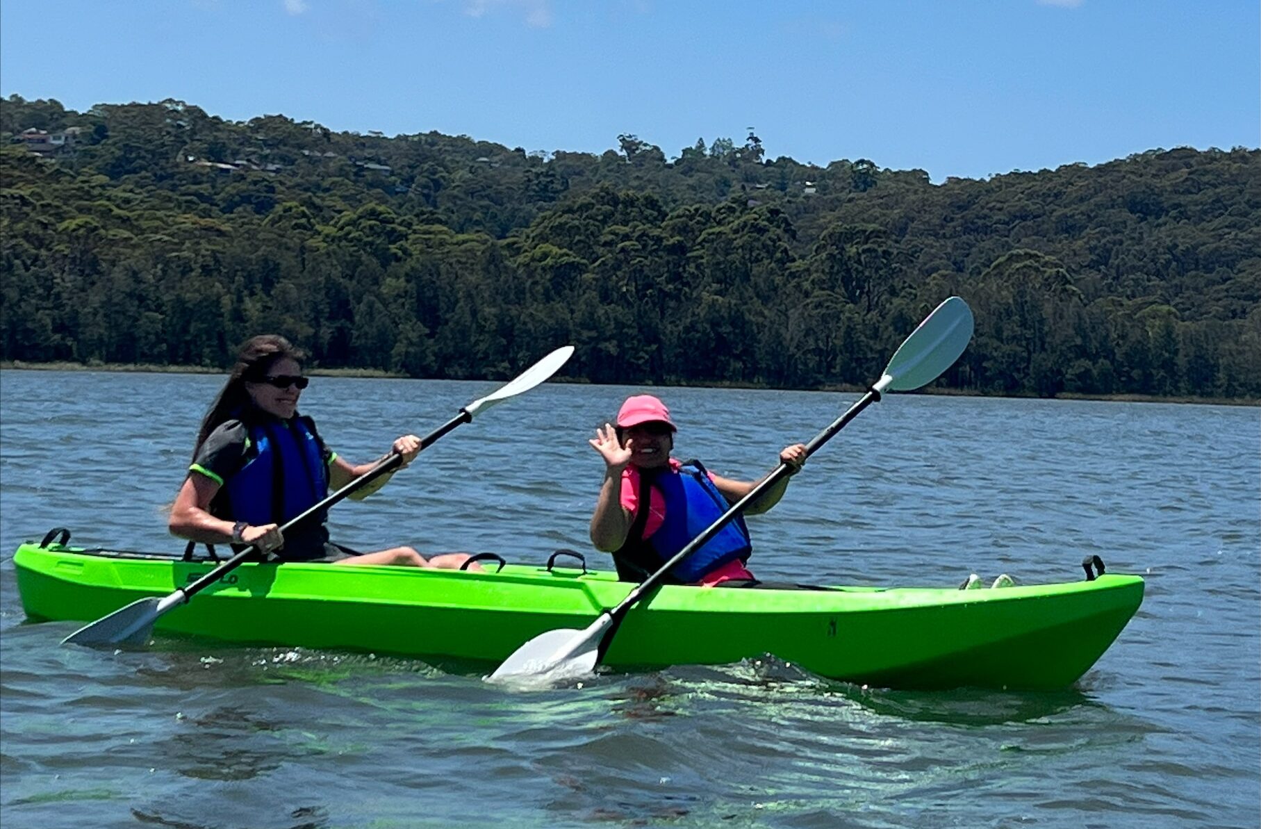 Two females kayaking on a river