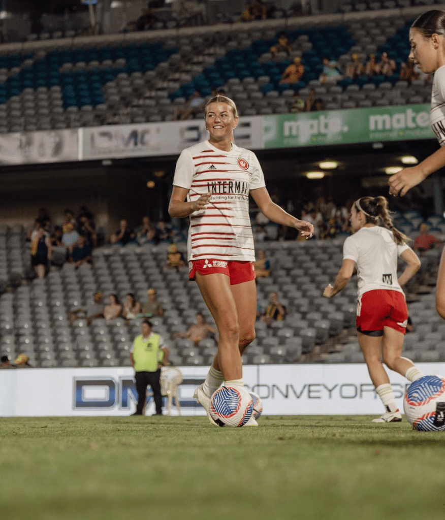 Sophie Harding in a warm up playing soccer on the field for the Western Sydney Wanderers.