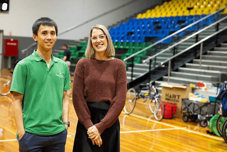 Rex and Jess from the CPA team, smiling together in a gymnasium