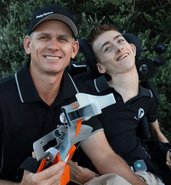 Riley and his father Clint with their Polyspine support.