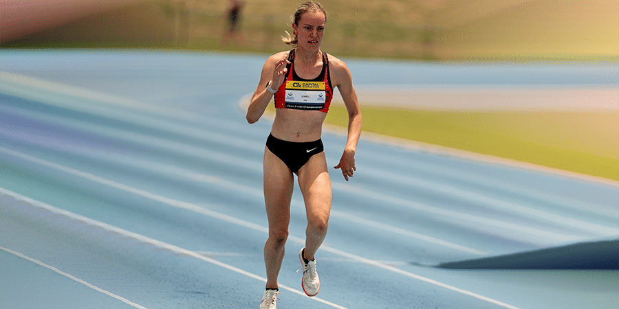 Mali Lovell running on a track in a running race