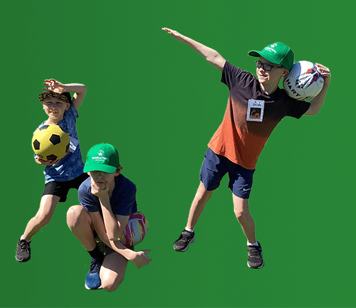 Three young boys striking poses with soccer balls