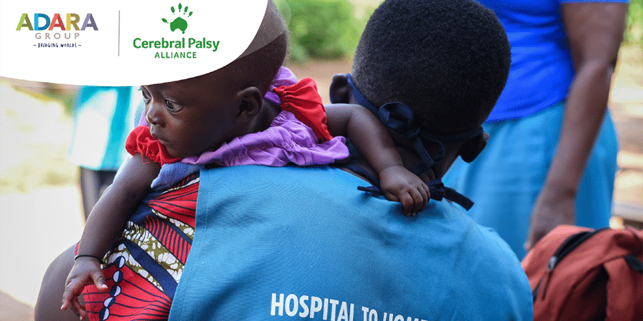 A community health worker carrying a small baby in Uganda