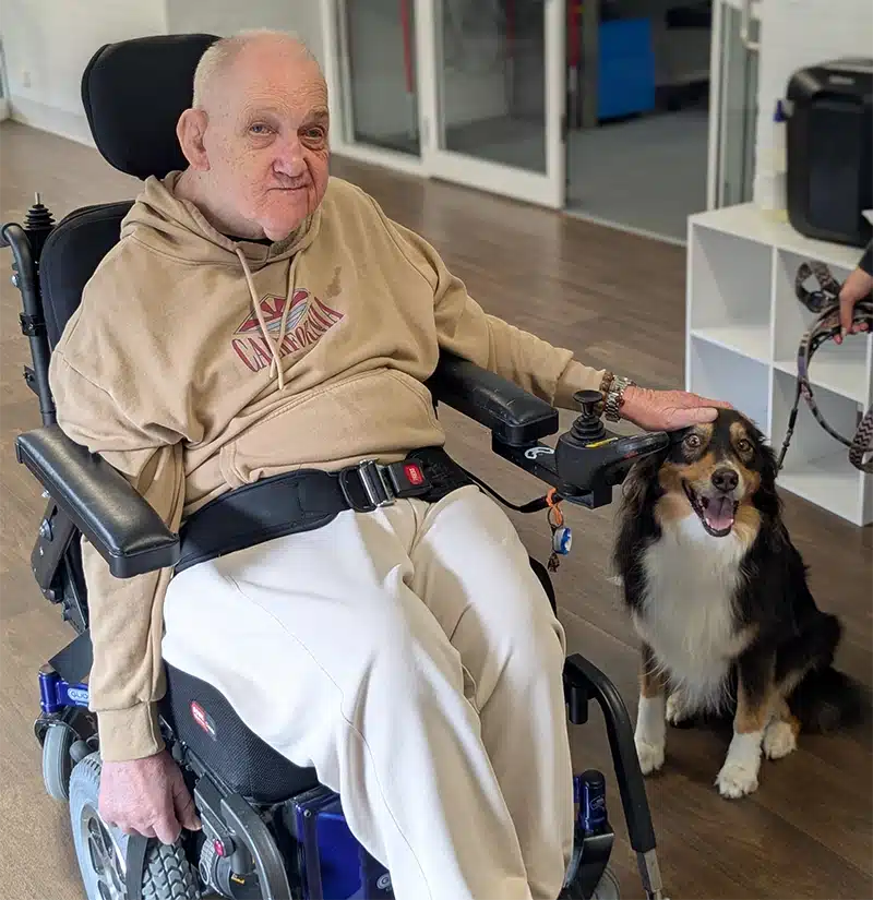 Lifestyles client Graham enjoying time with the therapy dog Victoria.