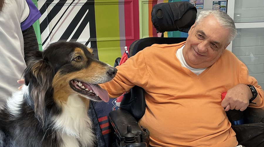 Lifestyles client Tony enjoying time with the therapy dog