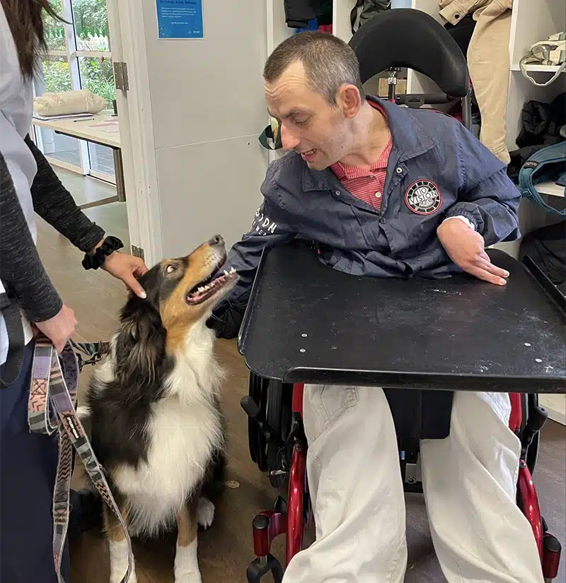 Lifestyles client Warrick enjoying time with the therapy dog Victoria.