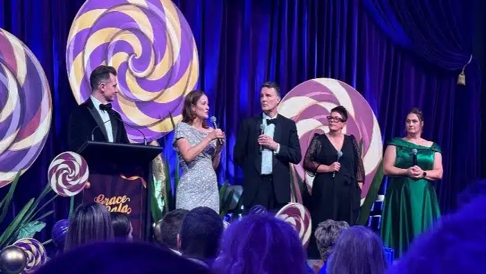Hosts on stage at the Grace Gala fundraising event