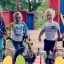 A group of young boys and girls with Cerebral Palsy, posing for a photo together in a playground