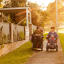 Male and female adult clients in wheelchairs outside at sunset
