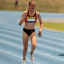 Mali Lovell running on a track in a running race
