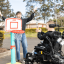 A boy in a power wheelchair and his therapist celebrating the achievement of a goal, to shoot a basketball into the hoop.