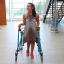 A young female client walking with her walking frame into CPA reception.