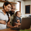 A pregnant mother looking up CMV information on a laptop with her husband and toddler